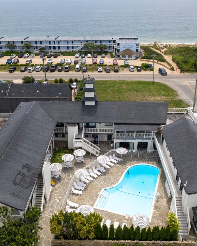 Aerial view of A Wave Inn, its pool, and the nearby Atlantic Ocean